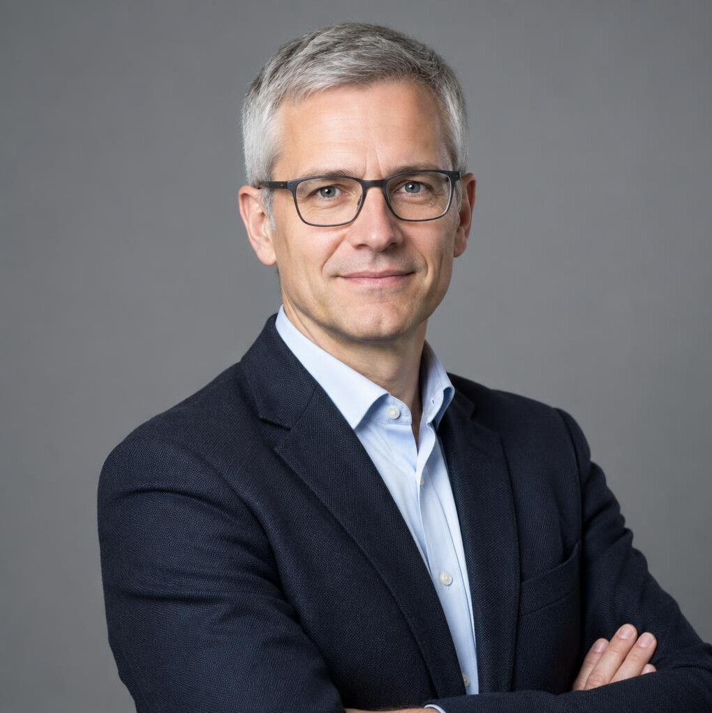 Portrait of a man in glasses and a blazer